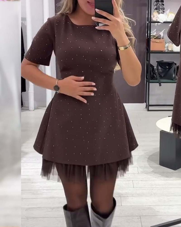 Elegant dress with a shimmering, mesh patchwork pattern