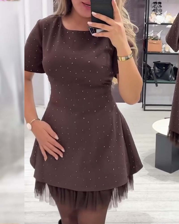 Elegant dress with a shimmering, mesh patchwork pattern