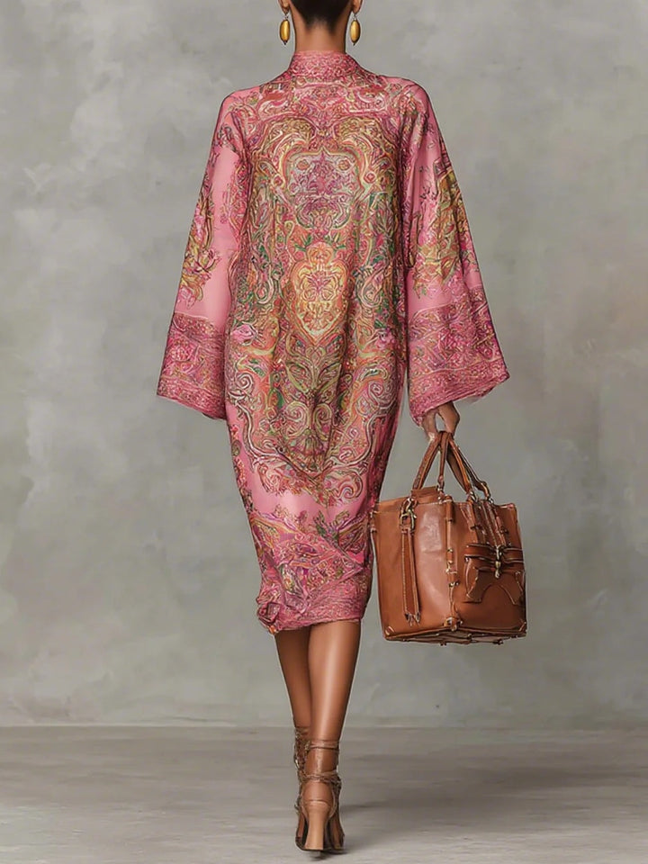 Pink midi dress with paisley pattern, featuring wide sleeves and long sleeves.